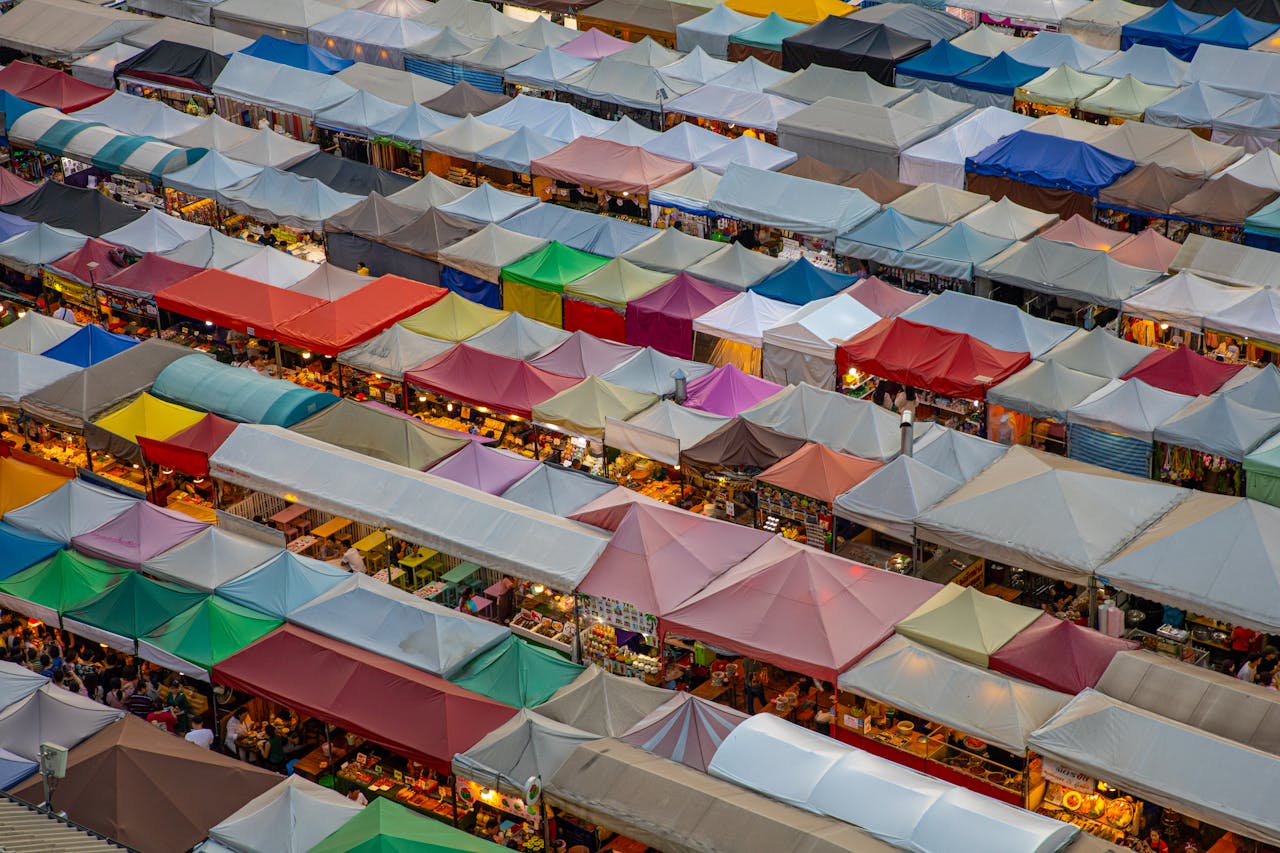 Colorful market stalls viewed from above, showcasing a lively traditional market.